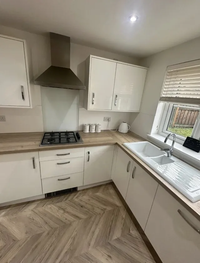 Herringbone flooring in a fitted kitchen